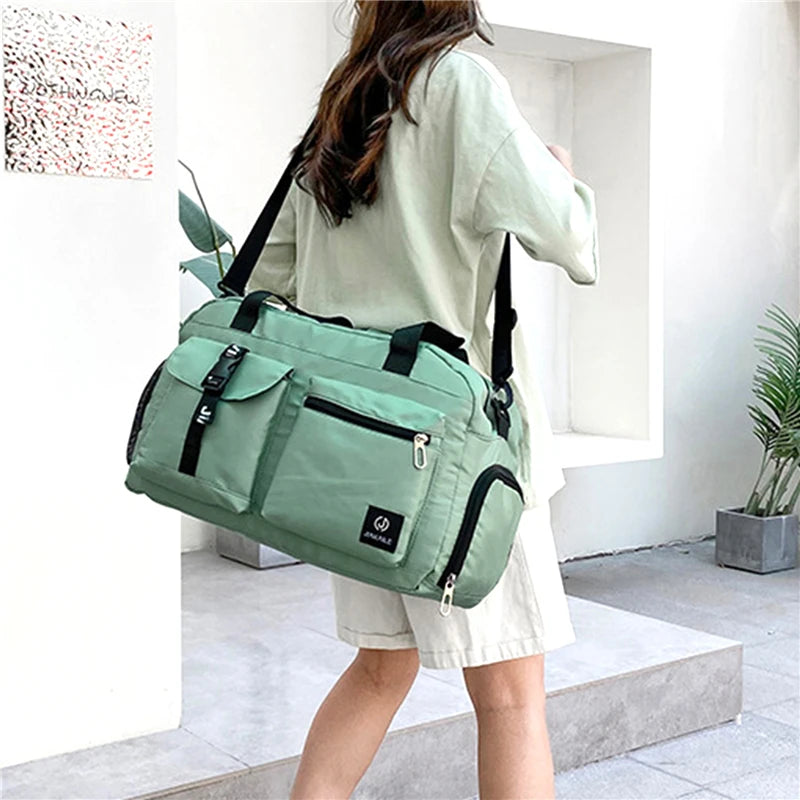 Green women's travel handbag with multiple pockets worn by person over shoulder from AliExpress