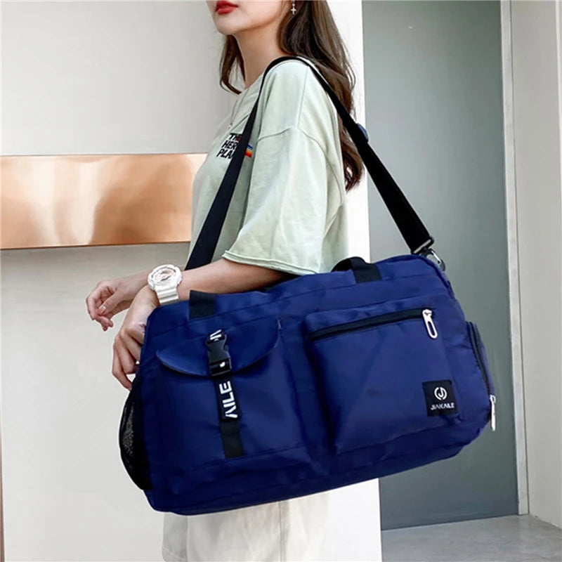 Blue women's travel handbag with multiple pockets and adjustable shoulder strap from AliExpress