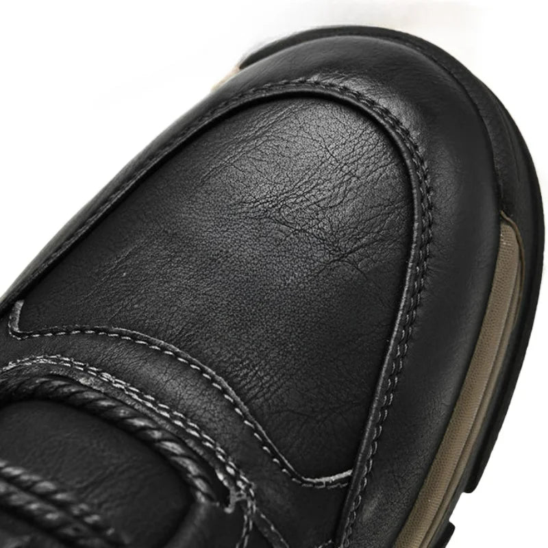Close-up of black men's casual outdoor sneakers showing detailed leather texture and stitching