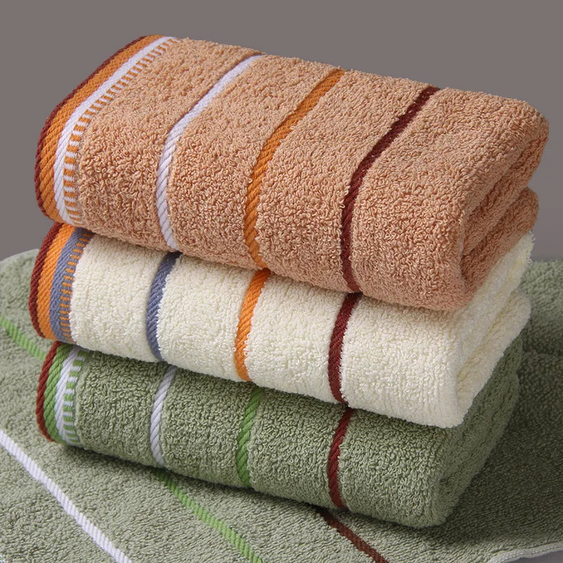 Stack of pure cotton bath towels in beige white and green with striped borders from AliExpress