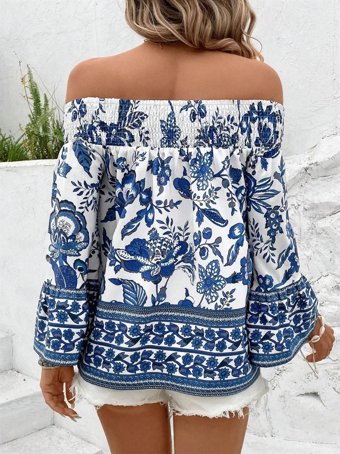 Trendsi smocked off-shoulder blouse with blue floral print and long sleeves on woman