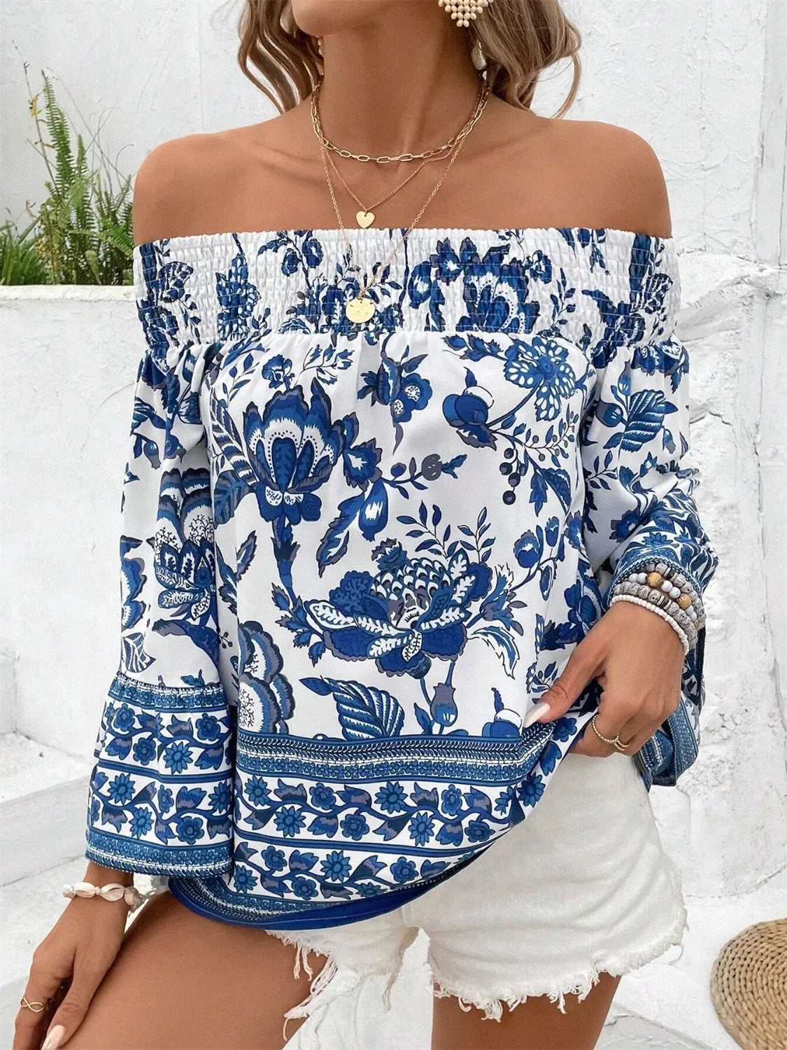 Trendsi smocked off-shoulder blouse with blue floral print and long sleeves